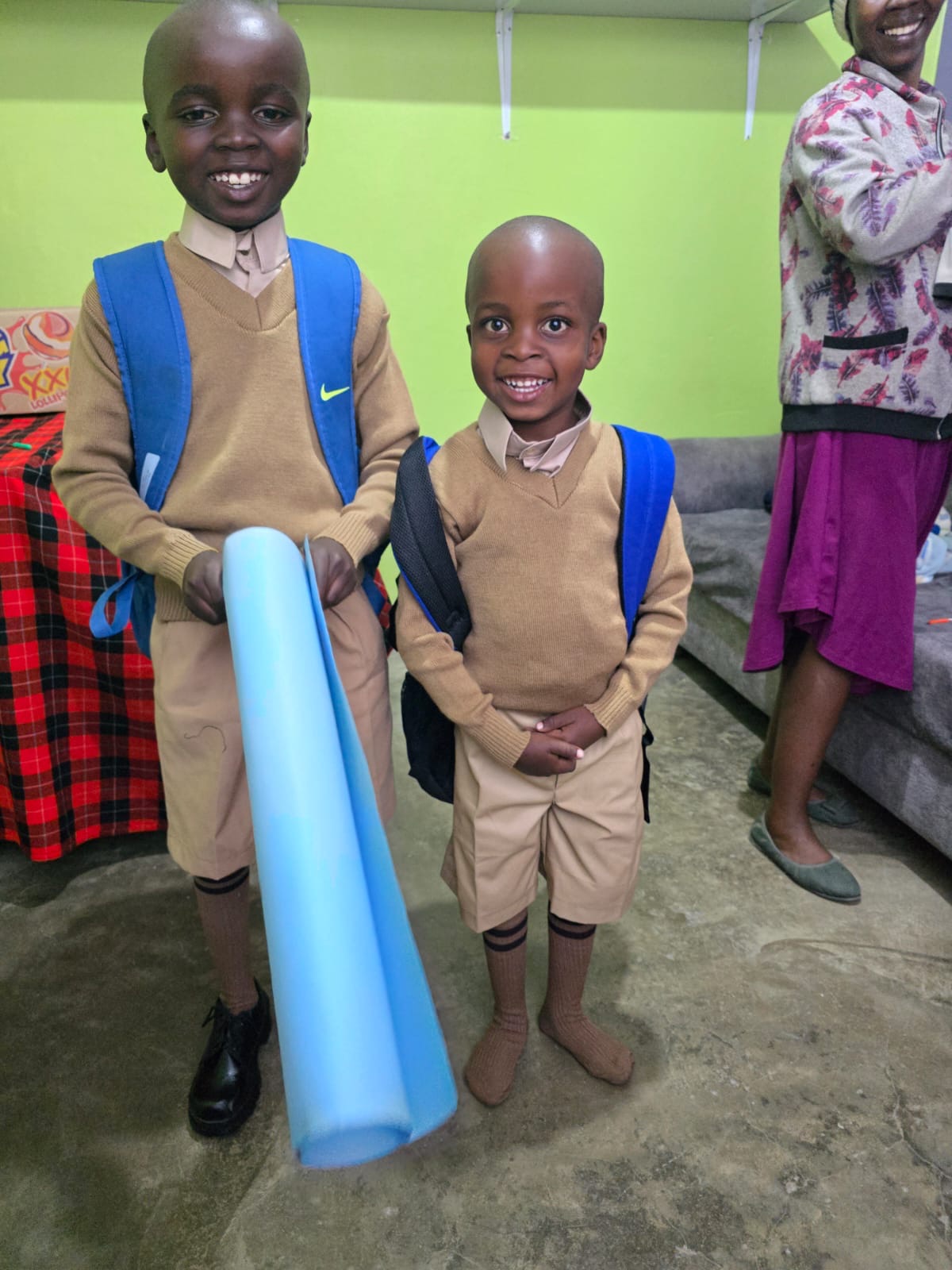 Two primary school students supported by OnCourse with new school supplies